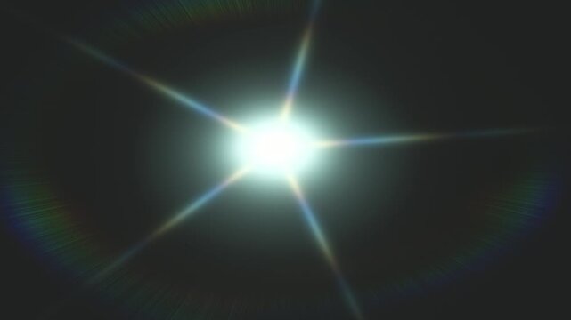 Bright central flare with starburst beams and rainbow diffraction set against a dark background now!