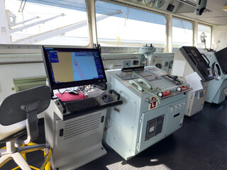 navigation bridge of the cargo ship, cockpit. navigation equipment, charts, radars, engine...