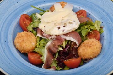 Salad with tomatoes, smoked ham, cheese and mayonnaise, Sliced ​​cherry tomatoes.Cheese balls and Thin slices of prosciutto with smoked ham with mozzarella and burrata