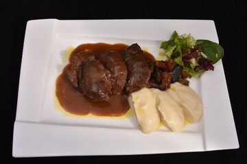 a portion of liver with sauce, served with a creamy puree and a green salad. Liver is a nutrient-rich food, being an important source of iron, vitamin B12 and vitamin A