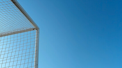 Minimalist Football Goalpost Corner Under a Clear Blue Sky