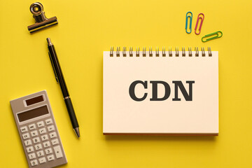 There is notebook with the word CDN. It is an abbreviation for Content Delivery Network as eye-catching image.