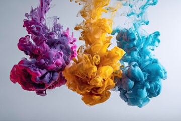 Three plumes of brightly colored liquid swirling, mixing, and dissolving