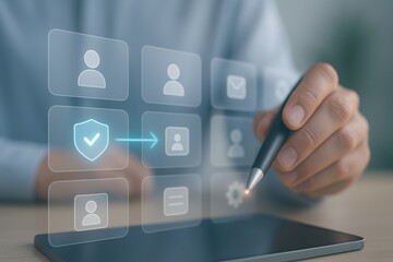 Person using stylus with holographic security shield and user profile icons on tablet symbolizing identity protection and authentication
