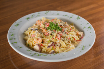 Creamy Seafood Fettuccine Alfredo with Shrimp, Calamari, and Parmesan