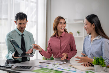 Business team discussing sustainability data at office meeting