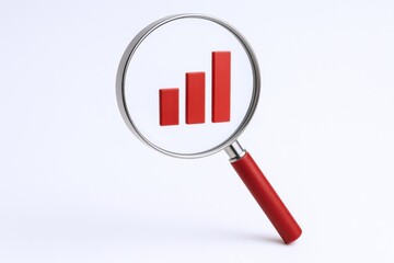 Magnifying Glass Focusing on a Red Bar Graph Indicating Growth and Positive Trends in Business