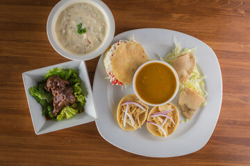 Traditional Mexican Antojitos Sampler Platter with Gorditas, Tacos, and Soup