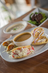 Traditional Mexican Antojitos Sampler Platter with Gorditas, Tacos, and Soup