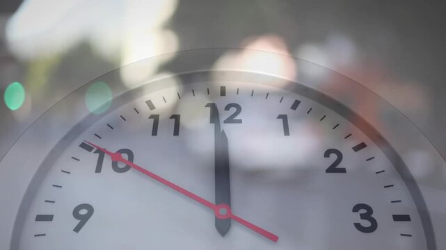 Clock face appearing with blurred street background, red second hand moving clockwise marking time