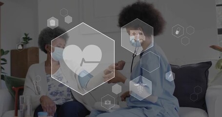 Senior woman lifting arm on sofa while nurse securing cuff, icons appearing for health monitoring - Powered by Adobe