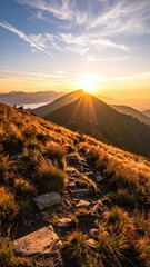 Sunlit Mountain Peak at Dawn with Grassland Trail and Radiant Sunlight