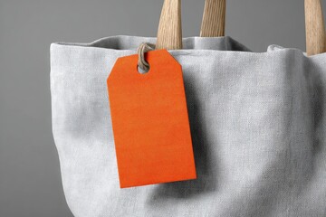 Light gray tote bag with orange tag