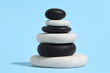 Stack of pebbles on blue background. Zen concept