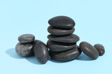 Stack of pebbles on blue background. Zen concept