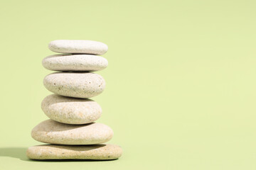 Stack of pebbles on green background. Zen concept