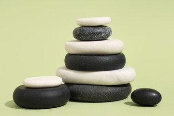 Stack of pebbles on green background. Zen concept