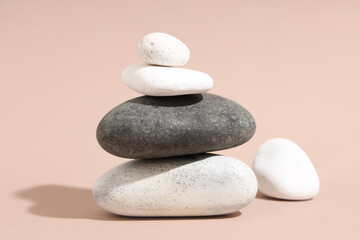 Stack of pebbles on beige background. Zen concept