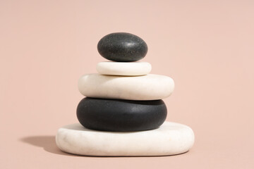 Stack of pebbles on beige background. Zen concept