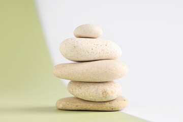 Stack of pebbles on color background. Zen concept