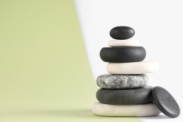 Stack of pebbles on color background. Zen concept