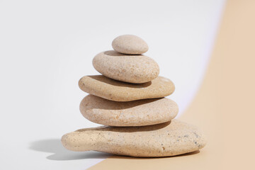 Stack of pebbles on color background. Zen concept