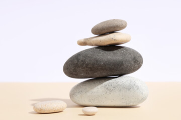 Stack of pebbles on color background. Zen concept
