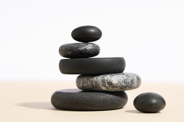 Stack of pebbles on color background. Zen concept