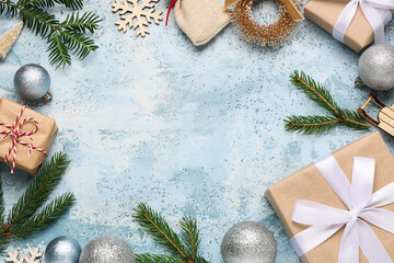 Frame made of gift boxes, Christmas balls and fir tree branches on blue grunge background, closeup