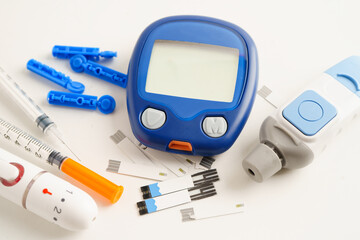 Glucometer lancet and  test strips testing blood sugar for diabetes. © Pakawadee