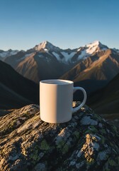 Morning serenity: Coffee mug atop mountain peak with snow-capped peaks, early sunlight and a clear sky backdrop