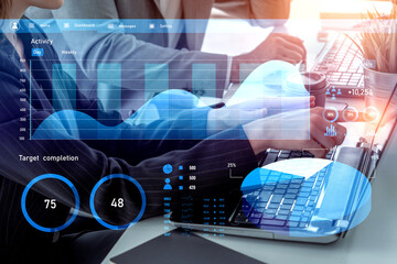Business professionals work collaboratively, analyzing data on a laptop. Graphs and charts illustrate performance metrics in a modern office setting. Impute