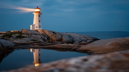 Lighthouse shining its powerful guiding light at dramatic dusk on a rugged rocky coast with a beautiful reflection in still water, serene seascape.