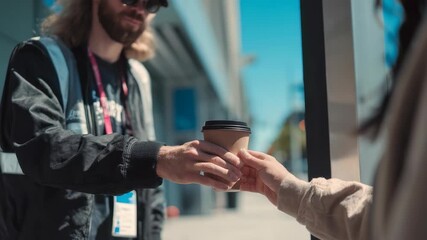 Two people interact as one hands paper coffee cup to other, highlighting connection, daily routines. Scene captures trendy city vibe with focus on casual street fashion, coffee culture