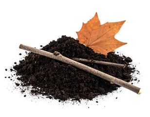 Pile of dark soil with twigs and autumn leaf