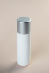 Cosmetic product in tube, bottle, lotion or serum with stylish props on light brown background. 