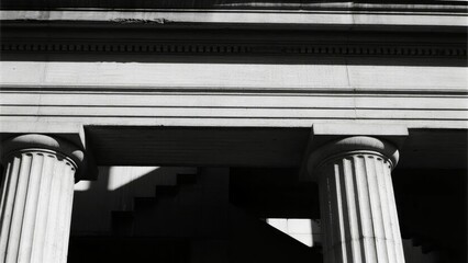 Black and white architectural detail of classical columns and entablature