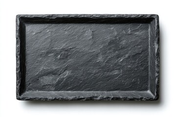 Fototapeta premium Overhead shot of a rectangular, textured, greyish-black stone serving tray with rough edges, shadow