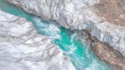 Birdâ€™s-eye view of a tundra slowly thawing in early spring, brown and green patches appearing through melting snow 