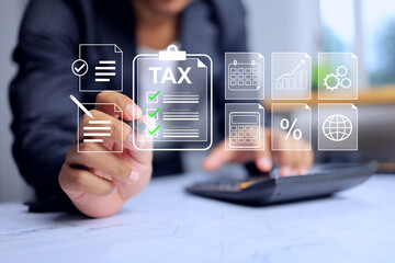 Tax concept with businessman tick checkmark on virtual interface and using calculator to calculation program to pay based on incoming earning in year