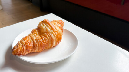 Golden Croissant on a White Plate