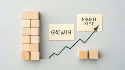 Visual Representation of Business Growth with Wooden Blocks and Profit Rise Graph on Grey Background