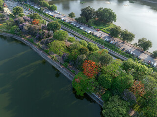 Aerial view of Le Duan street, lakeside park with colorful trees and calm waters in Hanoi.