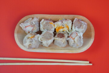 Dim Sum with Sauce on Red Background