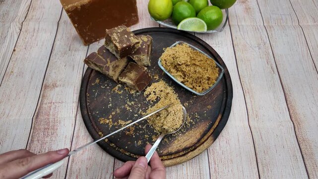 Hands prepare grated panela in a rustic kitchen, capturing artisanal warmth and cultural tradition