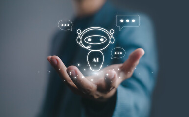 Businessman holding AI chatbot hologram with headset, representing virtual assistant, customer service, and digital communication technology for automation and artificial intelligence innovation.
