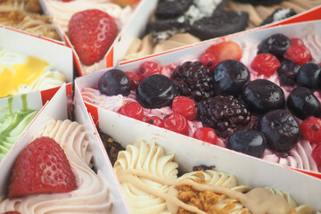 Colorful dessert trays filled with fresh berries and cream