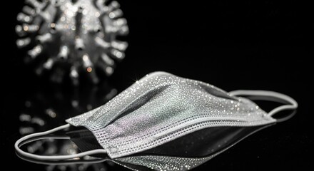 Sparkling Face Mask and Blurred Virus Model on Reflective Black