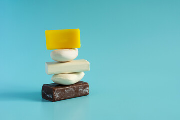 Soap as a means of protection from pollution and its beneficial properties. Various types of soap in the form of a pyramid close-up on a light background