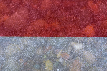 National flag of Indonesia on a background of snow with large snow crystals close-up